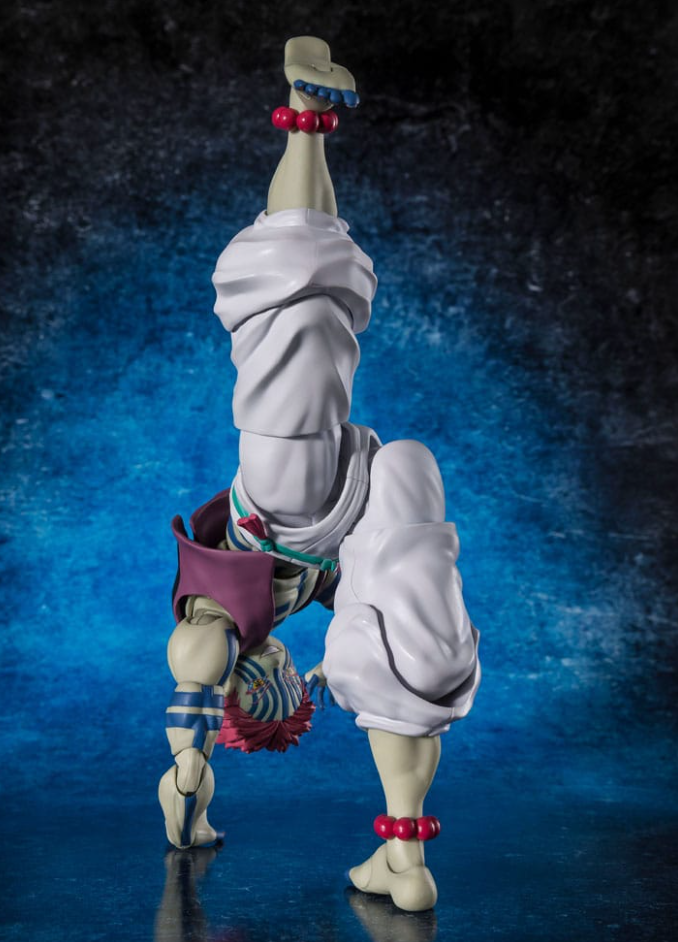 A collectible action figure of Akaza posed upside down in a handstand-like pose against a dark blue textured studio background. The figure has pale skin, white draped clothing, blue striped accents, red beaded ankle accessories, and a purple-and-red waist detail.