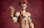 A collectible action figure of Sukuna character with spiky reddish hair, black tribal-style tattoos, and black fingernails, posed against a textured dark red background.
